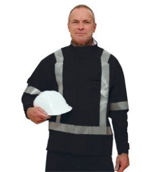 A man stands holding a white hard hat, wearing a black safety jacket with reflective stripes.