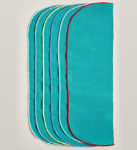 A stack of six turquoise, rainbow-edged Wrappers, Level 2, Single Ply, Merrow Edge with rounded corners, aligned vertically. These liquid-resistant fabric pieces from Lac-Mac, Limited adhere to the CSA Z314 Standard.